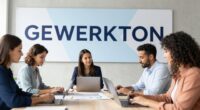 Five people work on laptops at a meeting table in front of a large wall banner reading GEWERKTON